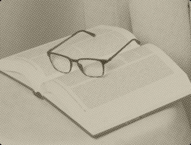 Book and glasses on a desk