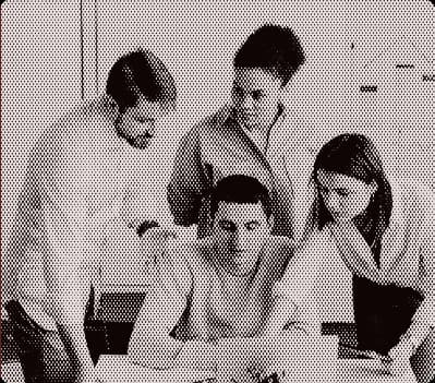 Group of people collaborating around a laptop